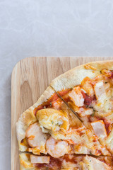 Delicious italian seafood pizza served on wooden table. Top view