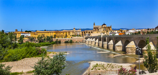 Fototapeta na wymiar Ancient Roman Bridge Entrance River Guadalquivir Cordoba Spain