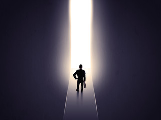 man looking at opened concrete wall