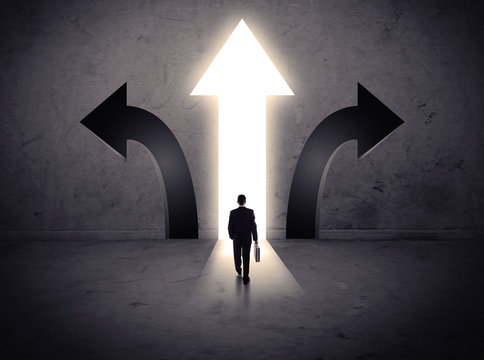Businessman in front of three arrows