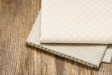 Dotted beige fabrics on wooden table