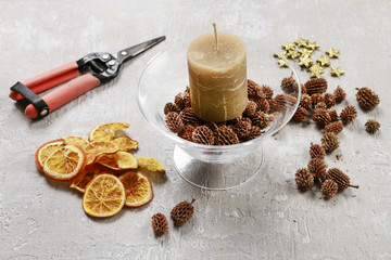 How to make candle holder decorated with cones and dried fruits.