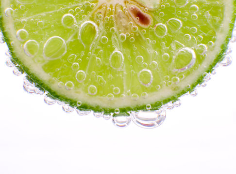 Close-up Lime In Sparkling Water White Background