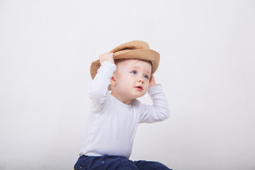 Little girl with hat on a white background.