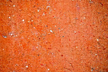 Grunge spatter painted cement wall and Peeling texture orange background or Abstract hole on cracked plaster concrete. Vintage and retro for poster background. High quality. Close up