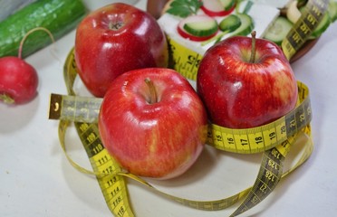 Diet - slimming .Weight loss concept with red apple, vegetables and dairy products
