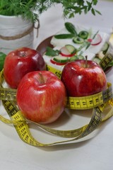 Diet - slimming .Weight loss concept with red apple, vegetables and dairy products
