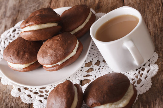 Tasty Whoopie pie and coffee with milk close-up. horizontal
