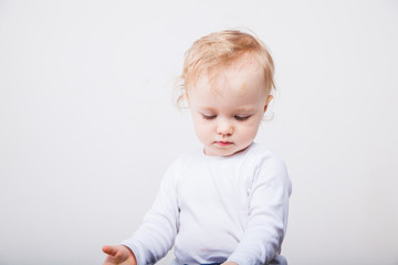 Fototapeta premium Little girl a on white background. Portrait