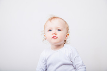 Naklejka premium Little girl a on white background. Portrait