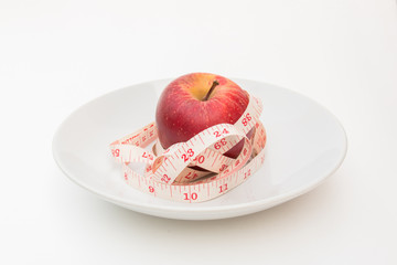 Red apple and tape measure