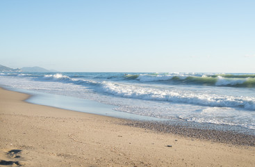 Fototapeta na wymiar Big waves in the Mediterranean sea on a clear sunny day.