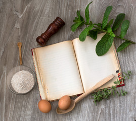vintage recipe book and food ingredients over wood
