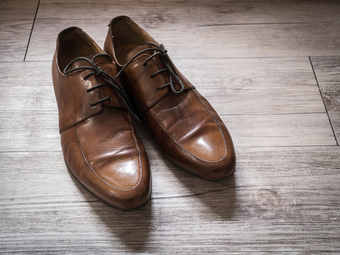 Vintage retro of men brown leather shoes on a wooden floor