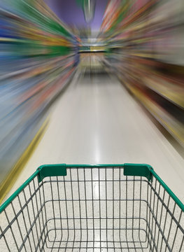 shopping cart in supermarket with motion blur
