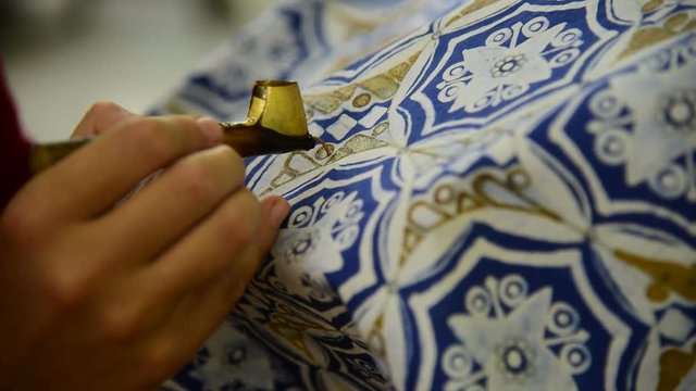 
Waxing the patterns on the textile for batik
