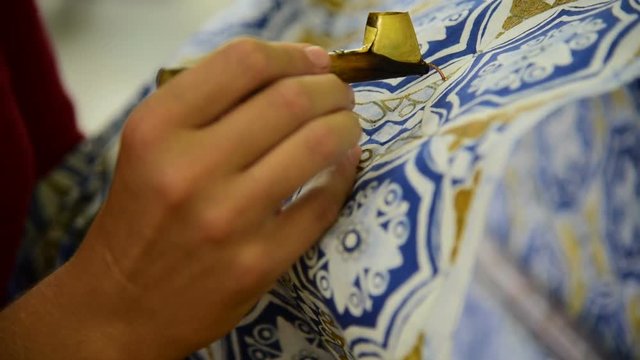 
Waxing the patterns on the textile for batik