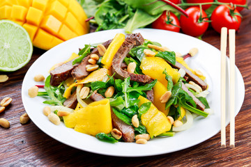 Fresh Tasty Mango, beef salad with vegetables and nuts.