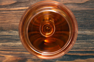 Fototapeta na wymiar Glass of wine on wooden table. Top view