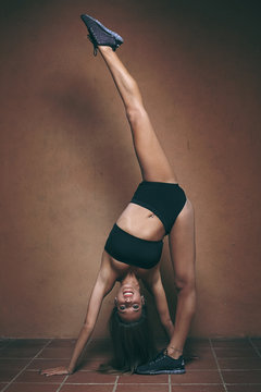 Dark portrait of a gymnast stretching