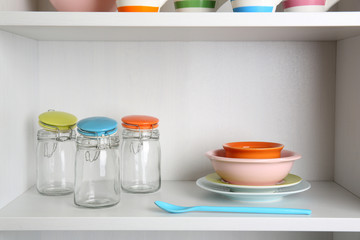 Tableware on shelf in the kitchen cupboard
