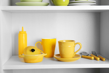 Tableware on shelves in the kitchen cupboard