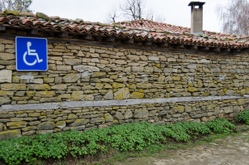 invalid parking sign on old stone wall