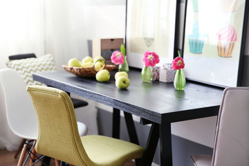 Modern room interior with table, chairs and pictures on the wall
