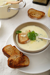 hot soup in ceramic bowl with toasts