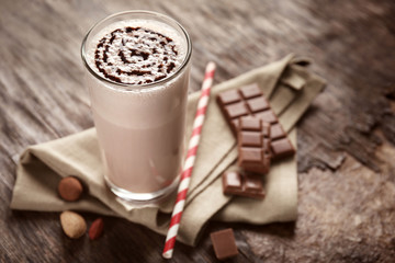 Delicious milk cocktail on rustic background, close up