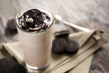 Delicious milk cocktail on rustic background, close up