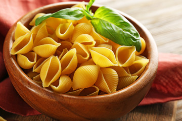Uncooked pasta with basil, closeup