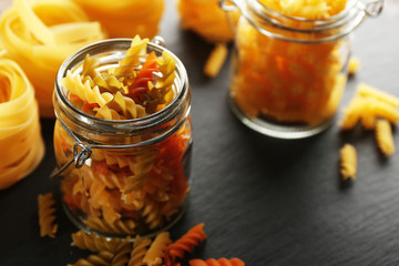 Fototapeta na wymiar Uncooked pasta in jar, closeup