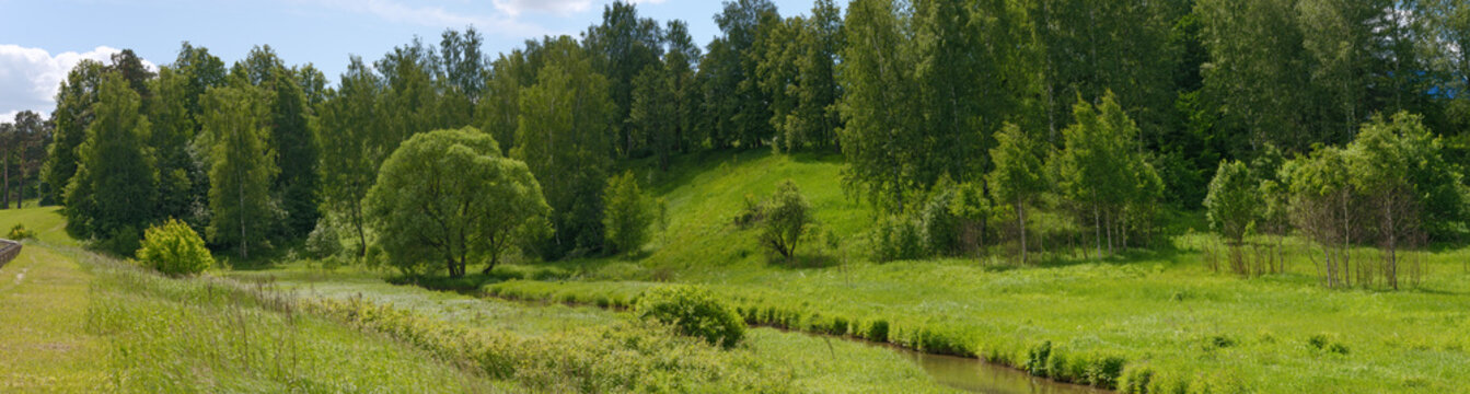 Bright green landscape of small river valley in Khotkovo, Russia