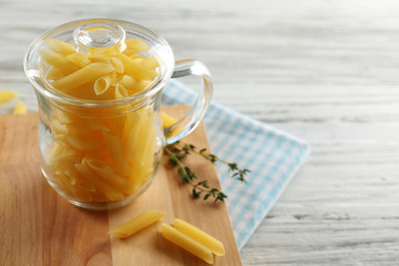 Raw pasta on wooden background