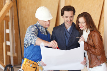 Worker shows house design plans
