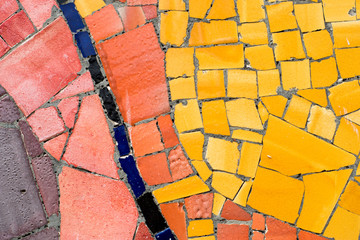 colorful mosaic of ceramic pieces on the wall, typical art  Gaudi style in Barcelona, Spain