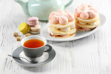 Cup of tea with delicious cakes