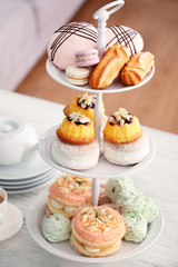 Cake stand with different sweets and tea