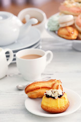 Cake stand with different sweets and tea