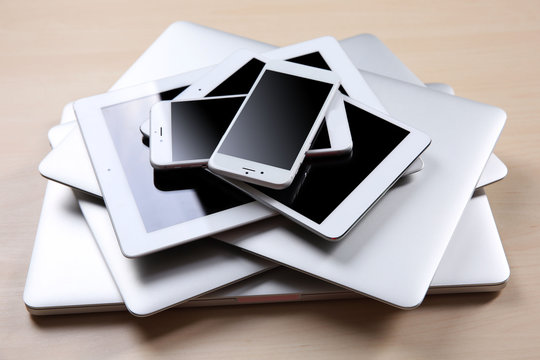 Stack Of Electronic Device On Wooden Table