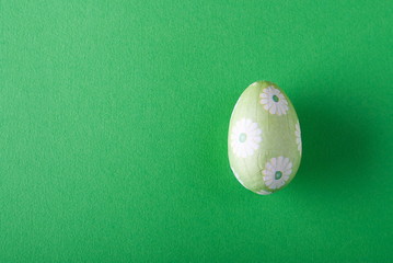 green easter egg on a green background