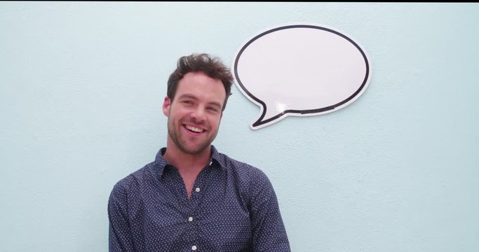 Handsome young man posing with speech bubble