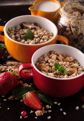 Healthy breakfast of muesli with strawberries, berries, milk and
