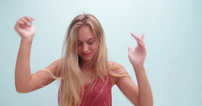 Fashionable young woman with long messy hair dancing