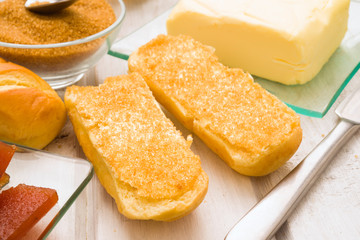 cut milk bread buttered and covered with black sugar