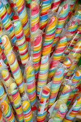 Sweet colorful lollipops on street market as a background