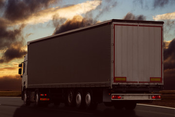Obraz na płótnie Canvas truck driving on the road dark landscape