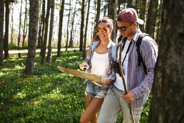 Couple hiking. Using map to get good direction.