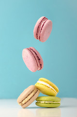 falling macarons on color background